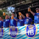 Row of men competing in steinholding event